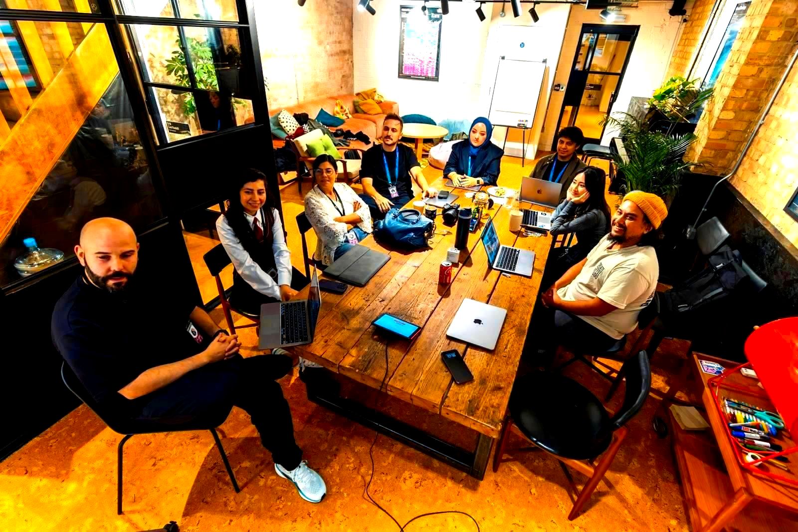 Diverse corporate team collaborating around a table in a modern office workspace