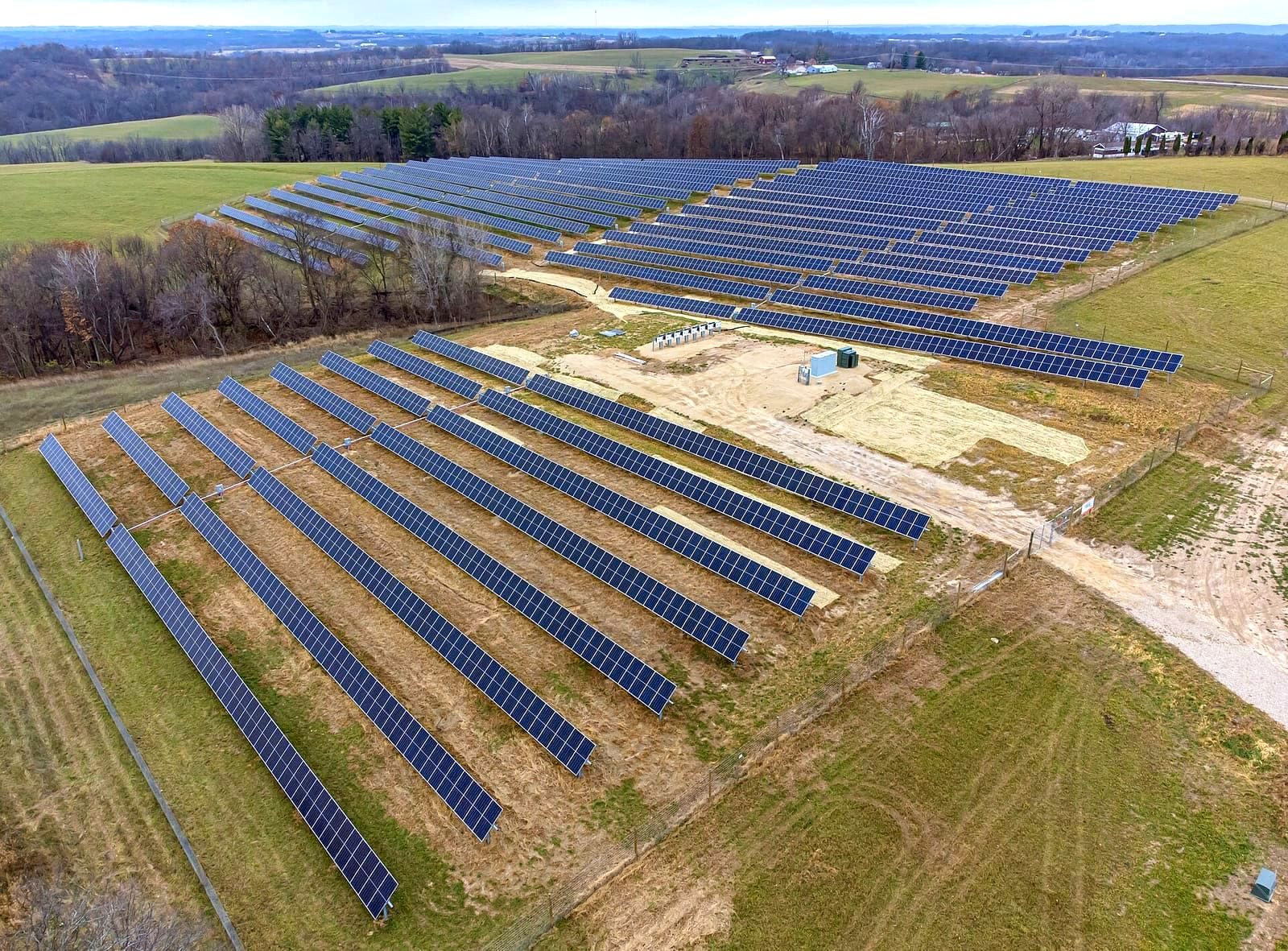 Large solar panel array in a field representing renewable energy generation