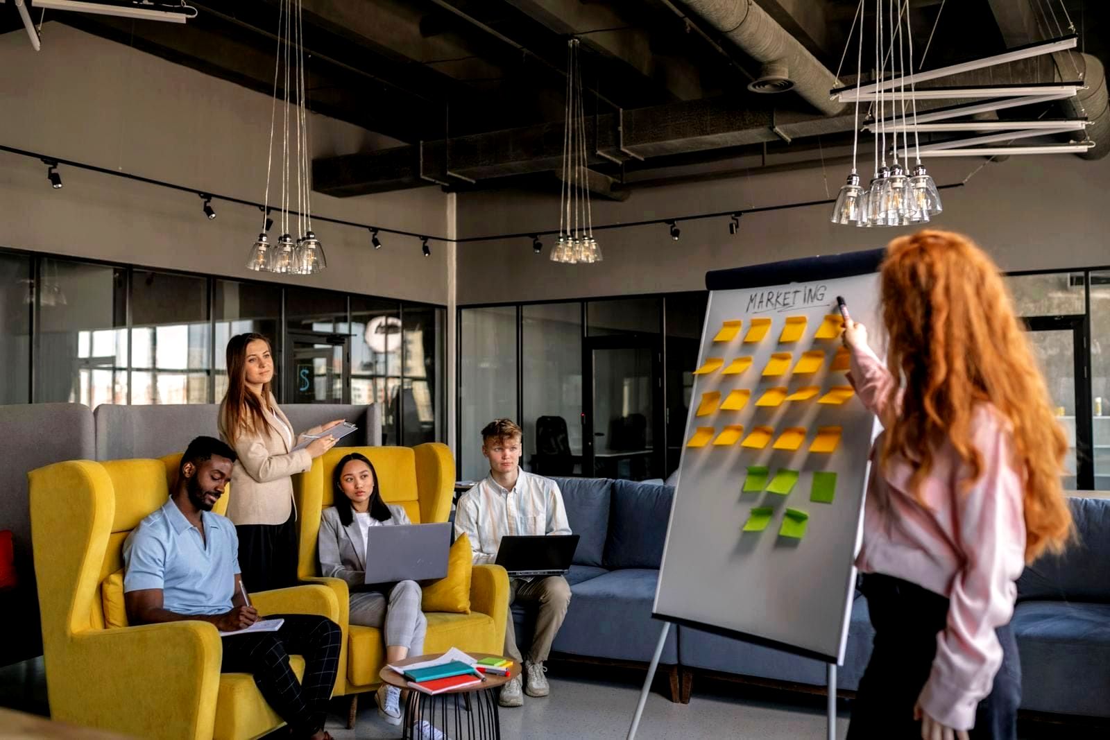Diverse group of professionals collaborating at a whiteboard in a modern office