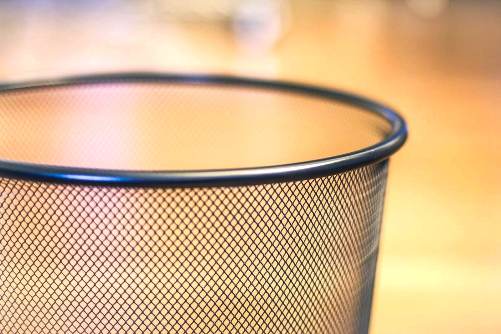 A wire-mesh metal street litter basket of the kind used on New York City sidewalks