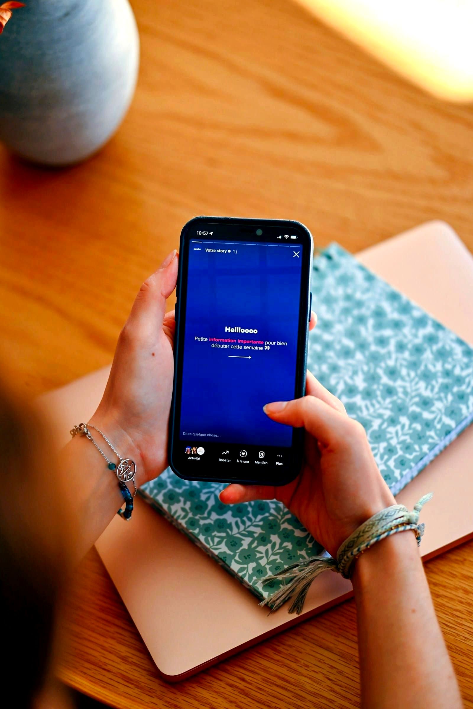 Hands holding a smartphone displaying a social media feed