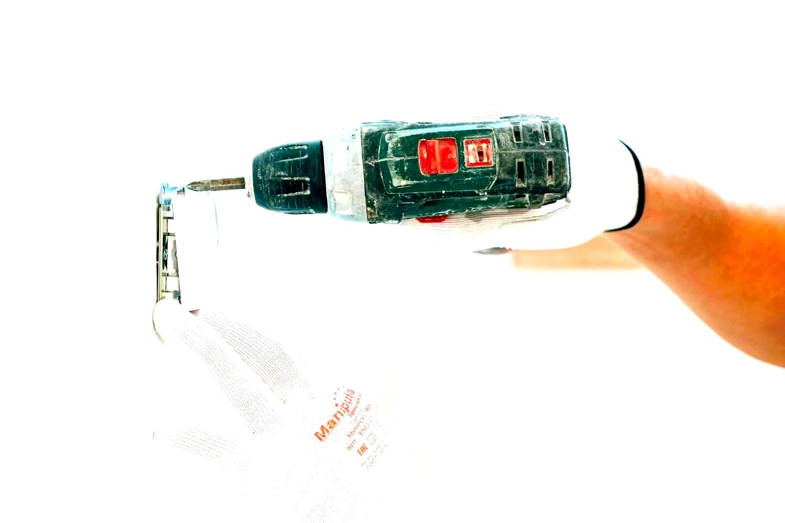 Worker using a power drill on a home improvement project in a workshop
