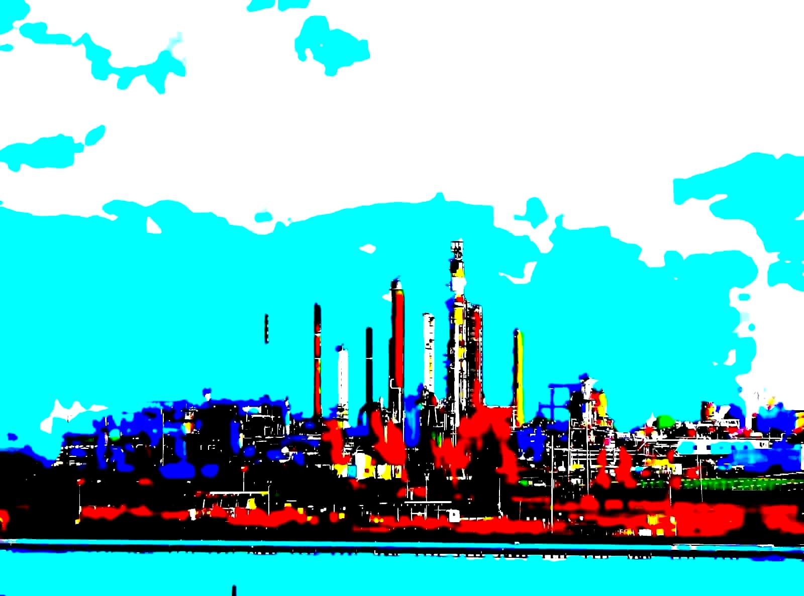 Industrial oil refinery at dusk with lit flare stacks and processing towers