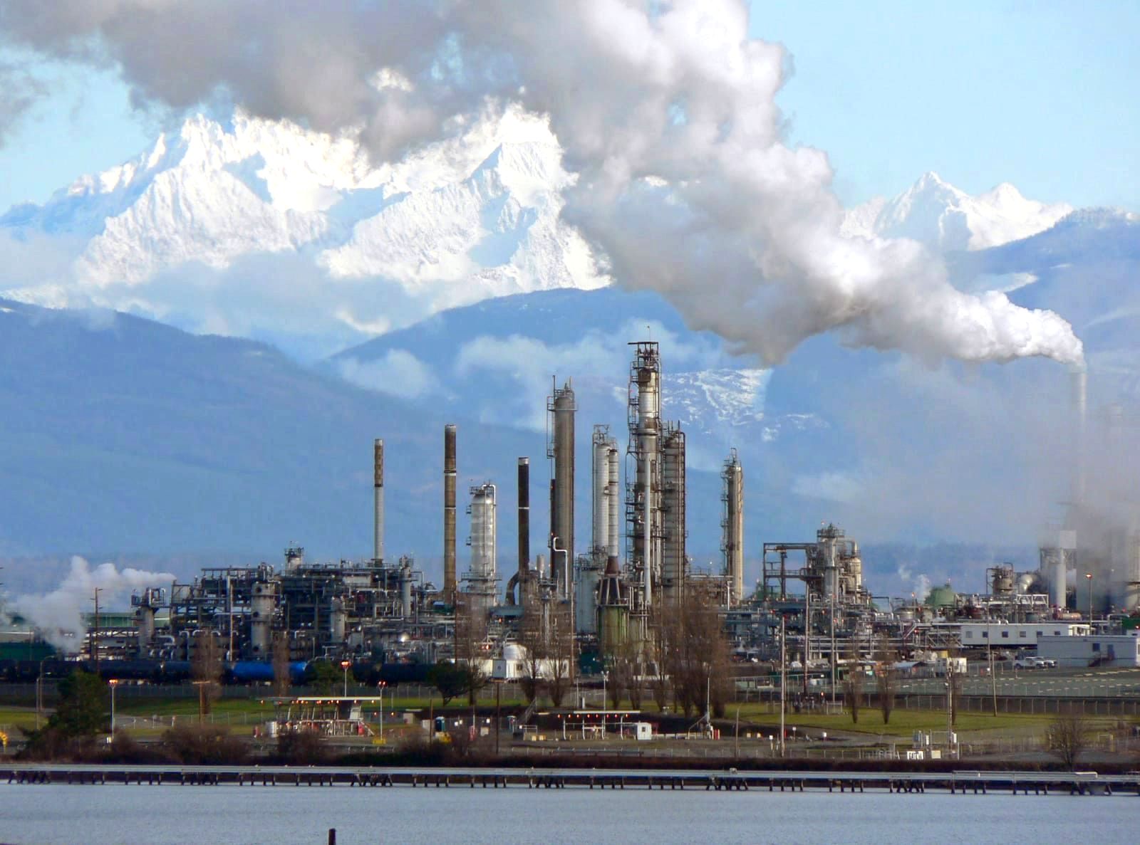 Large oil refinery with industrial processing units and storage tanks