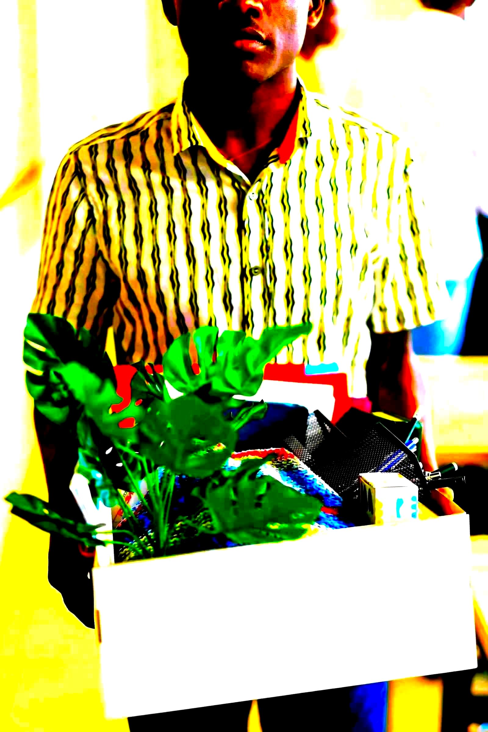 Workers carrying personal belongings leaving an office building