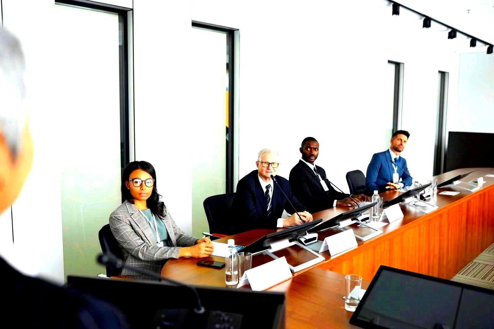 Diverse group of professionals seated around a conference table in a business meeting
